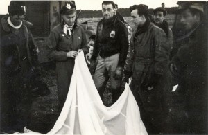 Swedish Home Guard examines a parachute as the stunned Liberty Lady crew looks on ...