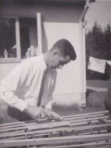 Charles Huntoon at Falun internment camp works on a canoe he is making for a local little boy.